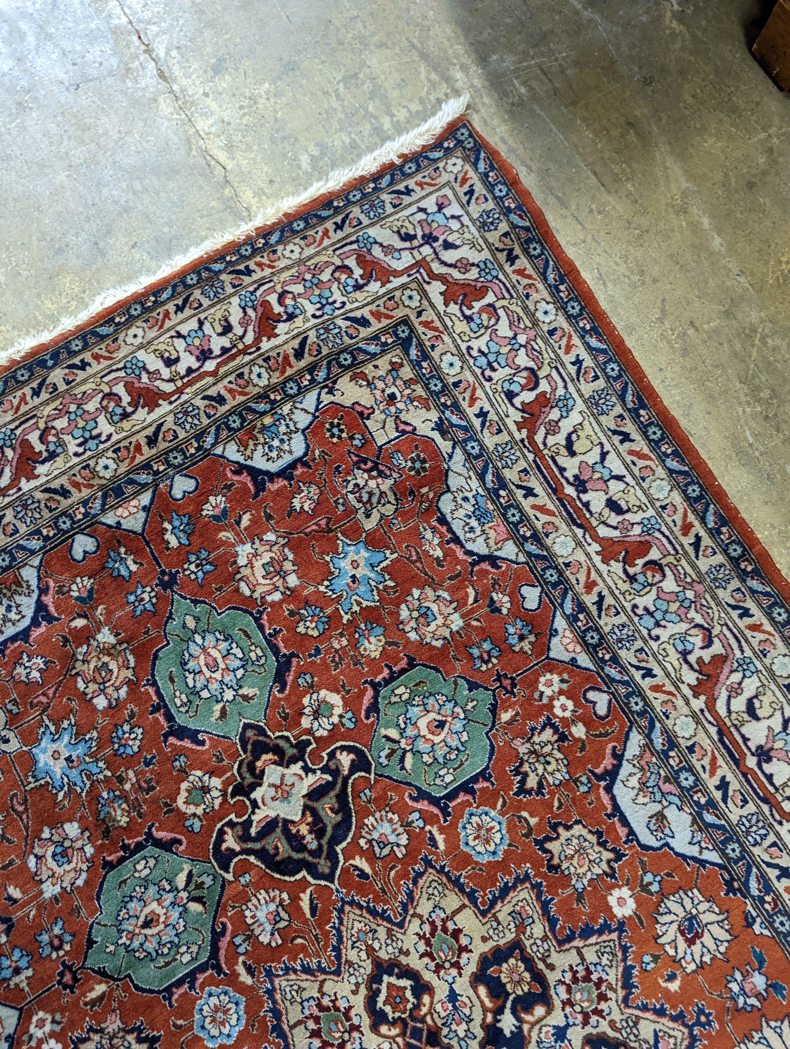 A Tabriz brick red ground rug, 230 x 138cm